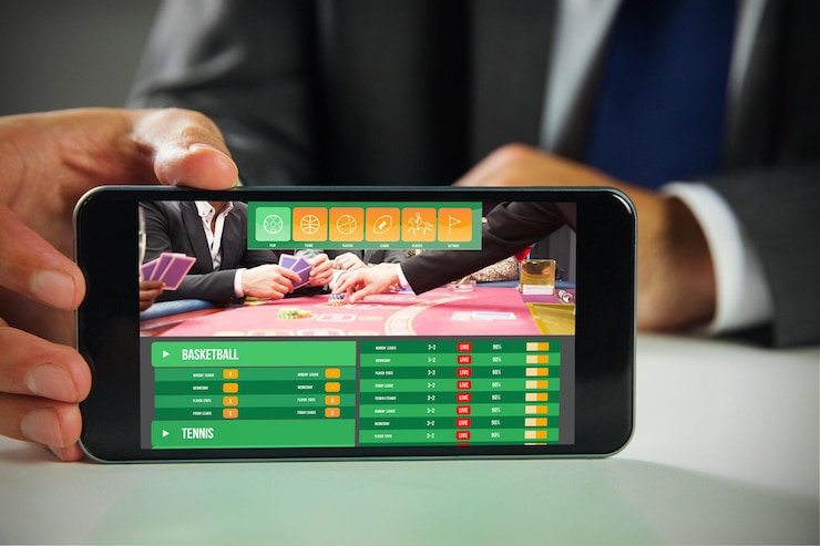 Pemandangan permainan sepak bola dan taruhan di layar perangkat pengguna di Jakarta